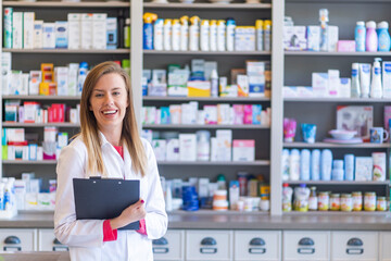 Hospital pharmacist worker. Portrait of cheerful smiling female pharmacist in pharmacy drugstore. Female pharmacists working in warehouse depot. Pharmacist posing chemist's shop