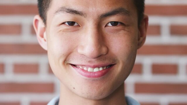 Portrait, smile and Singapore Asian man happy for success, joy and achievement at corporate company office. Startup employee or young person smiling for funny comic joke or comedy humor at agency job