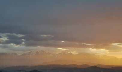 Fototapeta na wymiar hdr Un mare di luce inonda le montagne fra la nebbia al tramonto