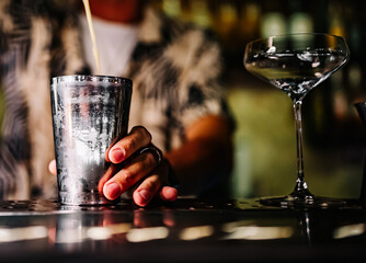 man bartender making cocktail in bar