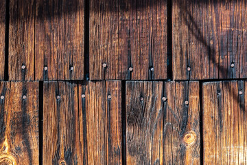 Grunge wood texture. Raw brown wooden wall background. Village building construction.