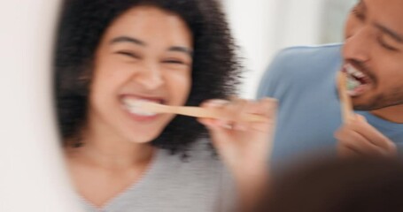 Love, mirror and couple in bathroom brushing teeth together in the morning, happy and smile. Man and woman with good dental health, mouth care and cleaning teeth with toothbrush and toothpaste