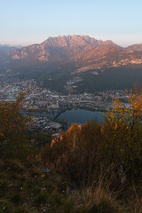 the alps, lakes and cities of brianza seen in the sunset light from the top of mount Barro, near the town of lecco, Italy - April 2022.