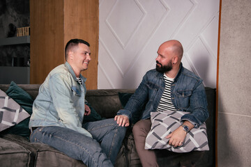 Adult gay couple resting at home. Happy family life of two men.