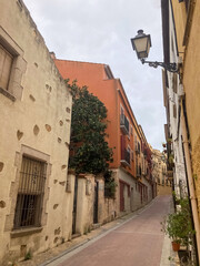Fototapeta na wymiar View of the narrow street in Tossa de Mar. 
