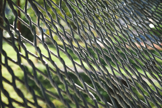 Close-up, selective focus on ropes on an old hammock. Idea for a background or screensaver.
