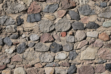 Old stone wall made of raw stones, background and screensaver idea