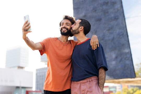 Happy couple enjoy outside. Gay couple taking selfie photo