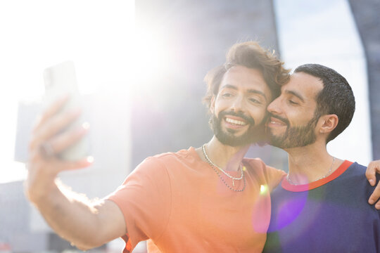 Happy couple enjoy outside. Gay couple taking selfie photo