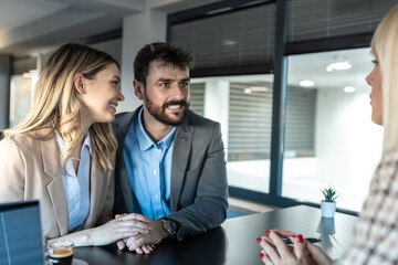 Young couple at meeting with marriage consultant in her office. They look happy and smiling