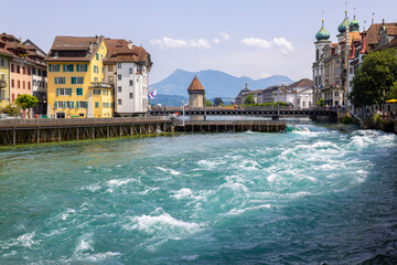 LUCERNE, SWITZERLAND, JUNE 21, 2022 - The rushing waters of the Reuss River in the center of...