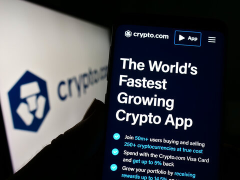Stuttgart, Germany - 09-24-2022: Person holding cellphone with website of crypto company Foris DAX MT Limited (Crypto.com) on screen with logo. Focus on center of phone display.