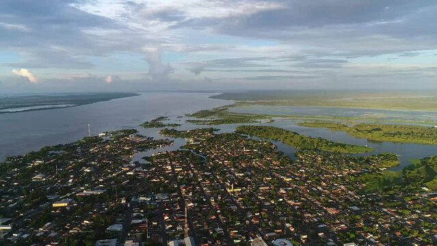 Drone take aerial view of the Parintins city from a great height on a cloudy day in Amazonas, Brazil