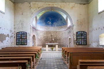 Poster interior of the old abandoned church with stone walls, view from behind the pews to the presbytery and altar © Roman