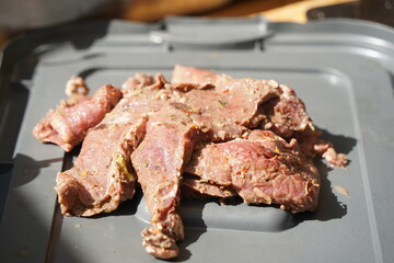 Roasting different pieces of beef for burgers and quesadillas.
