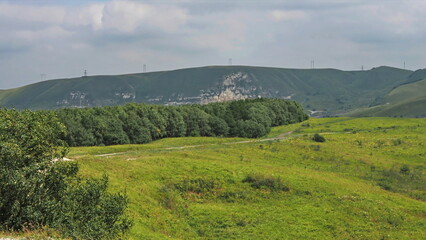 Obraz premium Panoramic views from Bolshoye Sedlo mountain to the Kislovodsk National Park and the city of Kislovodsk, North Caucasus, Russia.