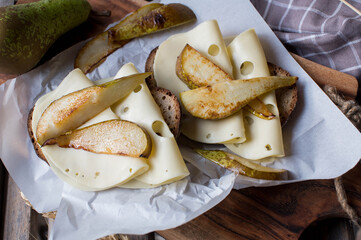 Cheese and fruit sandwich with edam cheese, roasted pears and toasted sourdough bread