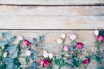 Beautiful bouquet with gerberas and lisianthus on old wooden background - greeting card - mother's day, birthday, wedding - top view with copy space