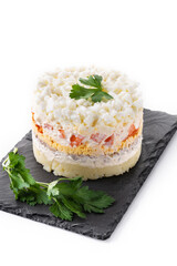 Traditional Russian layered salad Mimosa isolated on white background