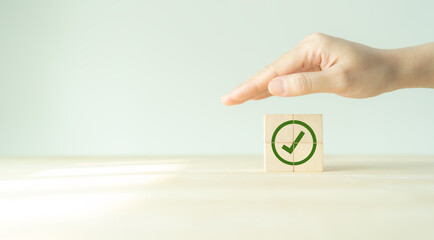 Corporate regulatory and compliance. Goals achievement and business success. Task completion. Ethical corporate. Do the right thing. Quality and ISO symbol. Wooden cube with green checkmark icon.