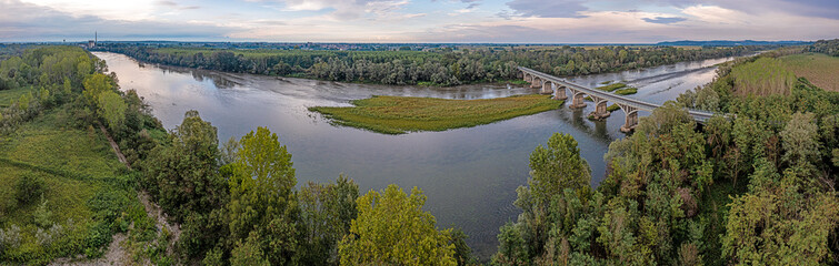 View of a bridge over the river Po in Piedmont in the drought summer of 2022 at low water level