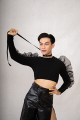 Beautiful Asian man wearing a black dance costume before the performance begins