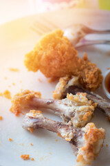 Chicken bones in the white dish