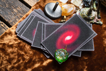 Tarot cards and zodiac wheel amulet on the old fortune teller desk table background. Future reading concept.