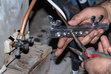 a professional technician is making die of metal pipes  