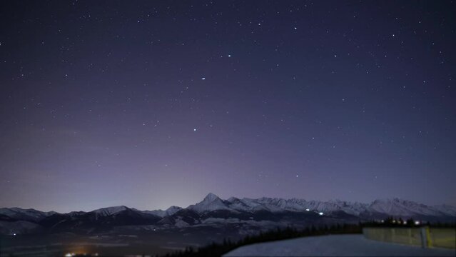 stars and sky night time lapse video of clouds mountain in background with bloom