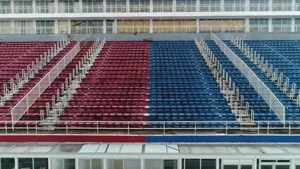 Drone zooms in at the seat of the Bumbódromo stadium which is colored in red and blue