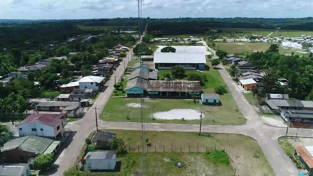 Drone fly above the church and capture the residential house in the city of Parintins, Brazil on a sunny day