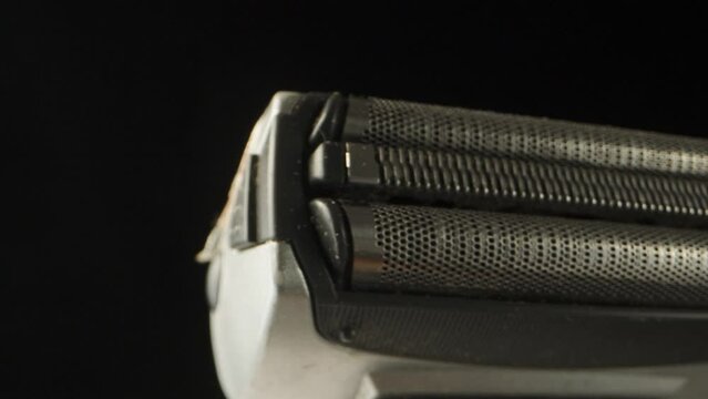 Shaving part of an electric razor, rotation close-up.