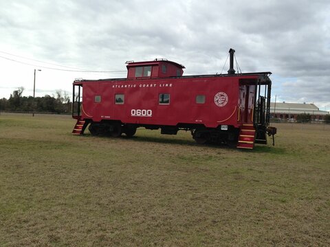 Old red caboose in a rail depot, Waycross, USA