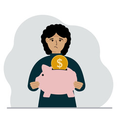 Sad woman holds a piggy bank, a coin falls into the piggy bank. The concept of saving finance, savings, investing finances.