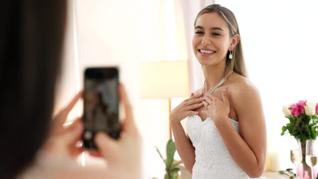 Wedding, jewelry and a woman taking photo on smartphone with happy portrait for fashion, luxury and confidence. Young bride smile with dress, diamond necklace and friends or people with mobile camera