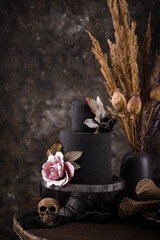 Halloween still life with skull, bones and cake