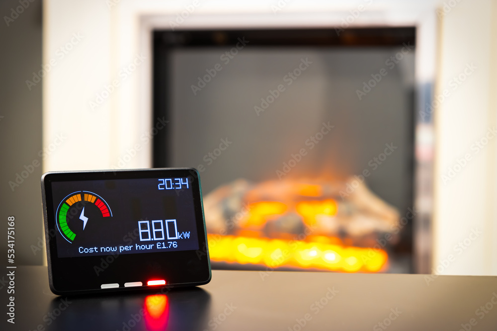 Wall mural Smart meter showing high energy costs and an electric fire in the background