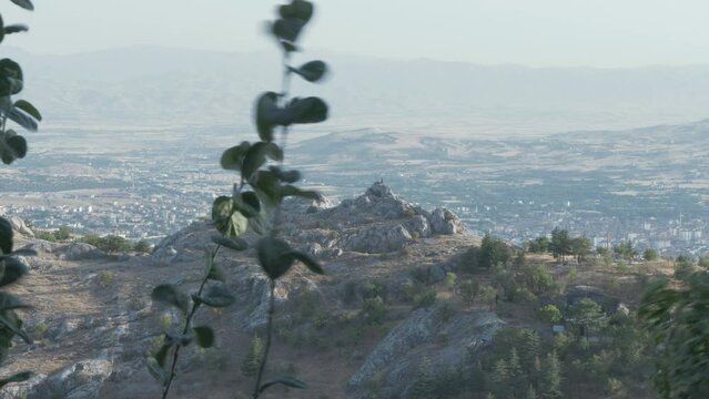 Rugged landscape medium wide shot through foliage Harput