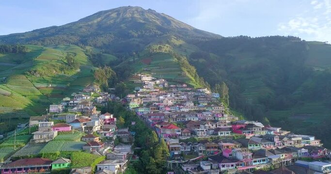 Aerial video of colorful countryside on the slope of moutain. Butuh Village that also called Nepal Van Java on the slope of Sumbing Mountain, Looks like Namche Bazaar - Central Java, Indonesia