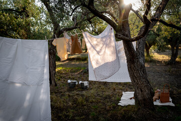 Baby clothes on clothesline drying in garden. Newborn childhood concept