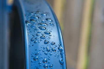 Water drops Abstract and with blurred background shines on a metal surface of a chair