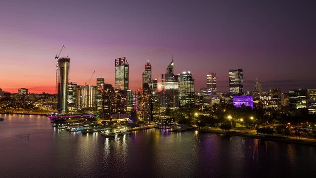 Hyperlapse at sunset dusk to night of city skyline from the water