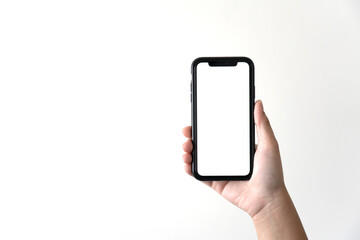 Woman hand holding black mobile phone on white background. Isolated hand using smartphone.