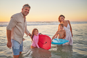 Family, beach and body board, kids with parents in water on summer holiday. Mom, dad and children...