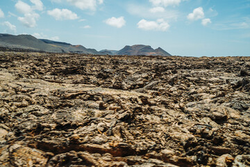 Arid volcanic landscape with lava fields in Timanfaya National Park, Lanzarote, Canary Island, Spain