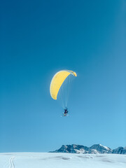 parachute parapenter flying mountains blue yellow