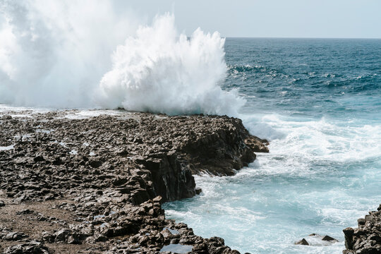 Water splash on black volcanic rocks of Tenesar, Lanzarote, Canary Islands