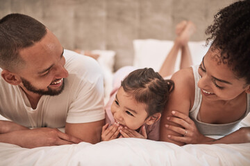 Fototapeta premium Mother, father and girl in bed in house bedroom, home interior and bonding on a morning. Family smile, happy and love bond parents or man and woman with young child in security, support or trust