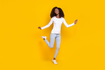 Fototapeta na wymiar Full body photo of overjoyed positive lady enjoy dancing clubbing have good mood isolated on yellow color background